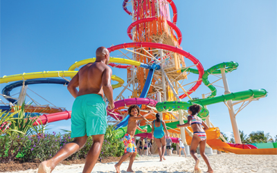 Image of a family walking towards waterslides.