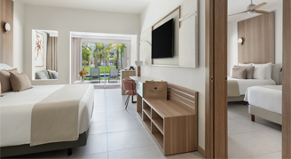 Image of three beds in a separated by a wall, one leading to a balcony.