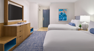 A view with two queen beds, with mounted tv.