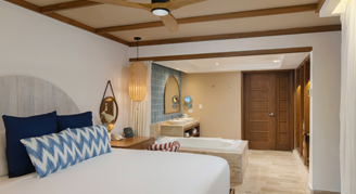 A view of one bed and bathroom area.