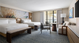 Photo of hotel room with two queen beds and seating area.