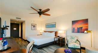 Image of a single bed and chair in a Deluxe Room.