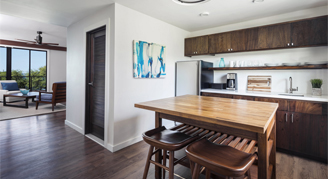 A view of the kitchen leading into the seating area in the Beach House Two-Bedroom Suite.
