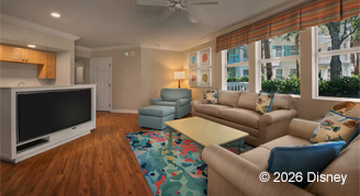 A mobility accessible two-bedroom villa featuring a large sofa set, Tv,  and a vibrant area rug.