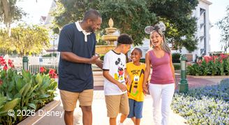 Family walking down path wearing Disney attire