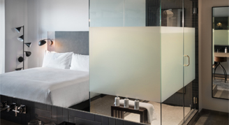 Photo of one king bed and bathroom space.