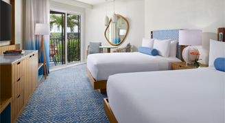 A view with two queen beds, furniture and balcony with a view.