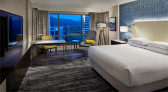 Image of a single bed and work area in a Standard Room.