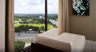 Image of a sofa looking out the window of a Partial-Lake-View Room.