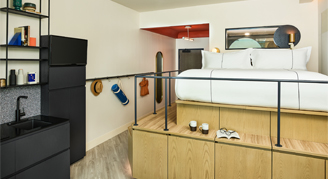 Photo of hotel room with elevated bed.