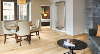 Image of a dining area and adjacent bedroom in a One-Bedroom Apartment.