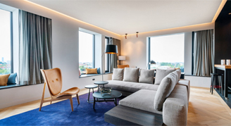 Image of the seating area and windows of the Executive Tower Suite.