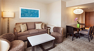 This image shows the living and dining area with couch and coffee table.