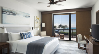 A view of a room with one bed and a balcony.