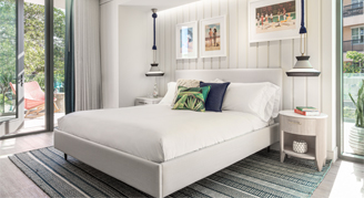 Image of a single bed with floor-to-ceiling windows in a Deluxe Room.