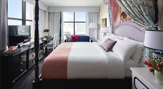 Interior view of the Premium Corner Room featuring city views and a king bed.