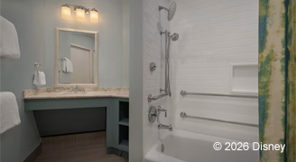 A mobility accessible bathroom featuring a tub and Vanity sink, mirror and lights.