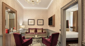 Image of a couch and chairs in a living area of a Presidential Suite.