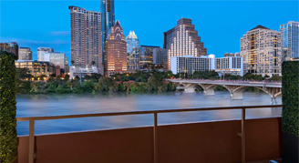 Image over a balcony overlooking the city as dusk in a Lake-View Patio Room.