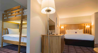 Image of king bed and bunk beds in a Luxury Family Room.