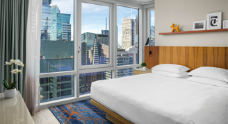 Image of a single bed in a Time Square-View Suite.