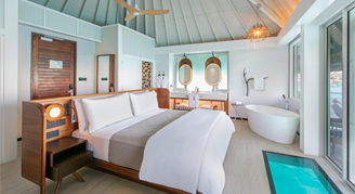 Image of a single bed and soaking tub in an Otemanu-View Overwater Bungalow.