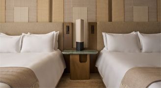 Image of two beds in a Tropical Garden Room.