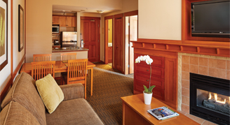 living room with couch, coffee table and fireplace.