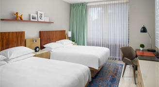 Image of two beds in a Room.