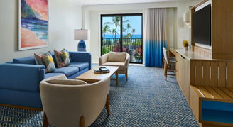 A view of living area with a small dining table, arm chair, and balcony with a view.