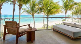 Image of the ocean and beach from a balcony in an Ocean-View Suite with Plunge Pool.