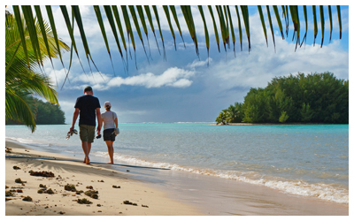 Couple walking down the beach in Rarotonga