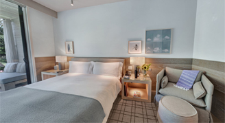 Image of a single bed in a Premium Streamside Room with Balcony and Outdoor Tub.