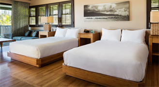 Image of two beds in an Ocean-View Bungalow.