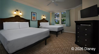 Light blue wall color featuring two queen beds and mounted TV. 