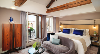 A single bed in a partial grand canal view room with a view of the patio.