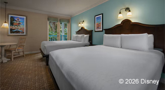 Hearing accessible deluxe studio with light blue wall color featuring two queen beds.