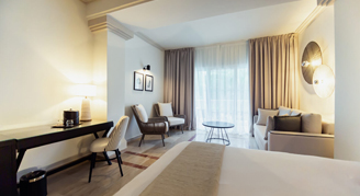 Junior suite featuring a king-size bed overlooking the ocean.