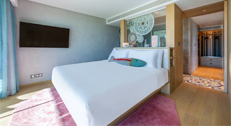 The image shows a platform bed with tv mounted.