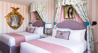 Graduate rooms featuring two queen beds and hearing accessibility features.