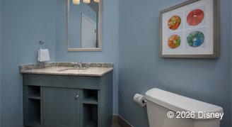 Mobility accessible bathroom  featuring a grey cabinet and beige vanity countertop.