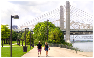 People walking along a wide path by the Ohio River.