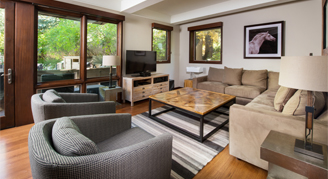 Photo of hotel room living space with large couch and balcony.