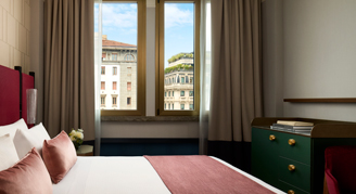 Photo of Deluxe Room with king bed and large windows.