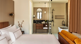 Photo of hotel room with king bed and small seating area.