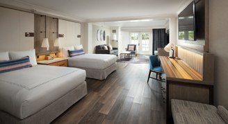 Image of a two bed and desk area in a Partial-Ocean-View Studio Suite with Balcony.