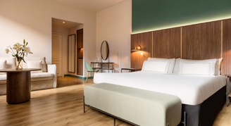 One king bed with seating area and vanity.