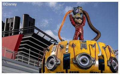 A thematic figure of Groot in a red jumpsuit standing atop the Groot Galaxy Spin attraction located in Marvel Landing aboard the Disney Adventure cruise ship