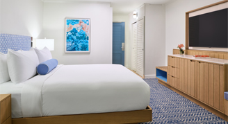 A view with king bed, with mounted tv.