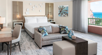 two bedroom regal suite with a king bed and sofa couch and lounge area.